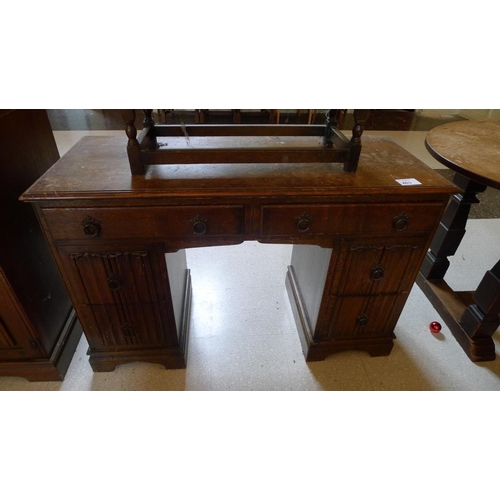 403 - An oak linen fold flat top desk with drawers under