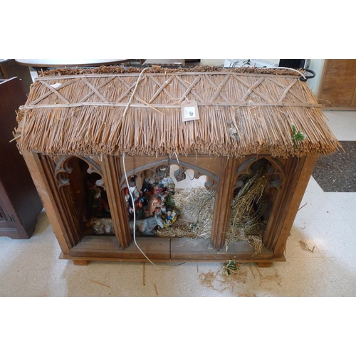 407 - A thatched Christmas crib with figures