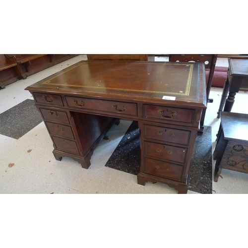 413 - A reproduction mahogany rectangular top pedestal writing desk with a tooled leather surface & 9 draw... 