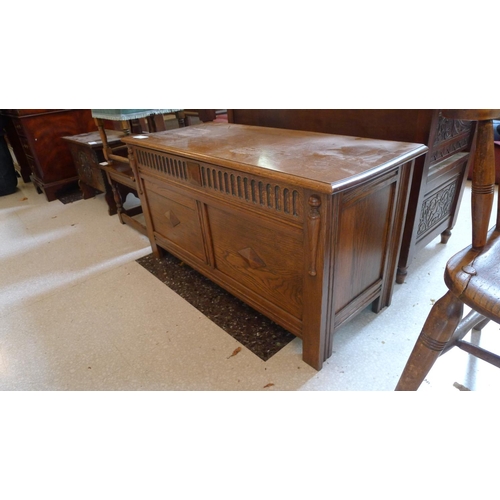 416 - A reproduction carved oak coffer with a lift lid