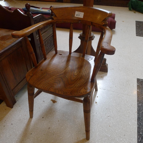 417 - An Edwardian oak smokers bow chair with spindle turned back