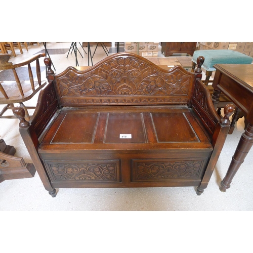 419 - A carved oak monk's bench with a lift seat