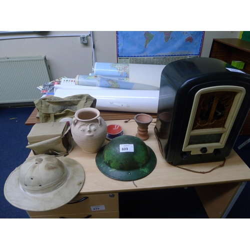 609 - A vintage Bakelite cased mains radio, a World War II metal helmet, a pith helmet,  and various other... 