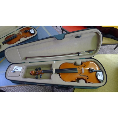 668 - A violin, bow and carry case