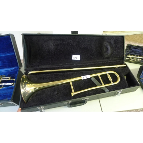 675 - A brass trombone by Boosey and Hawkes with carry case