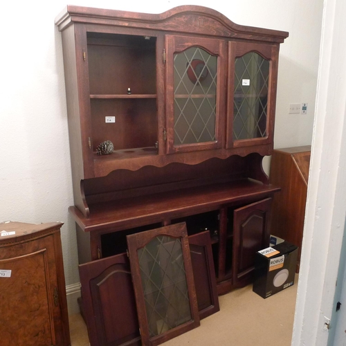 714 - A reproduction carved dark wood dresser with glazed doors above and panelled doors below