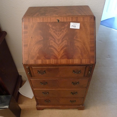 715 - A reproduction mahogany bureau with a fall front and 4 drawers under