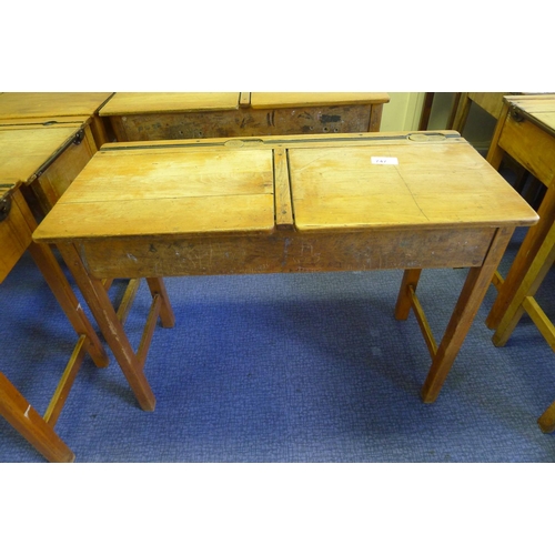 747 - A vintage wooden double classroom desk with lift lids