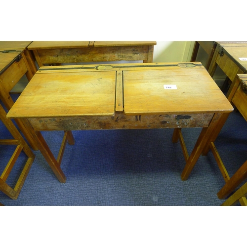 748 - A vintage wooden double classroom desk with lift lids