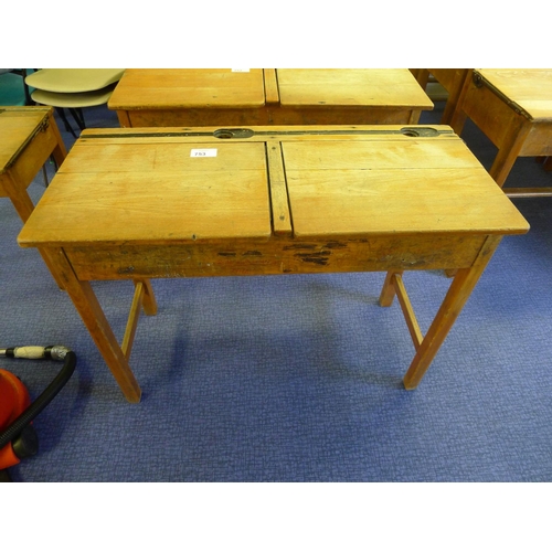 753 - A vintage wooden double classroom desk with lift lids