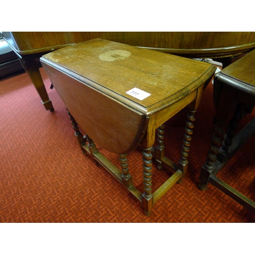 777 - An oak oval topped gateleg table with twisted legs