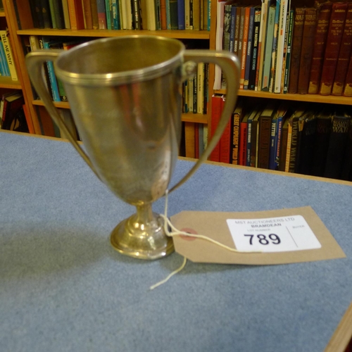 789 - A silver trophy cup  14 cms tall, weighted base