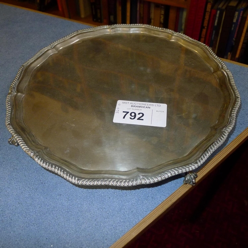 792 - A circular silver salver with 4 claw feet approximately 30cms diameter, approximately 860gms