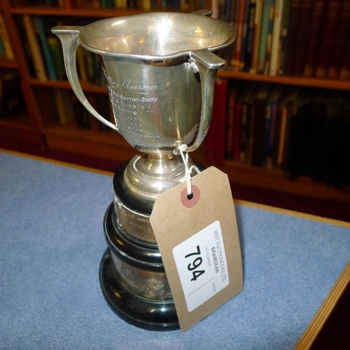 794 - A silver trophy cup 10 cms tall, approximately 103gms,with 2 small stands