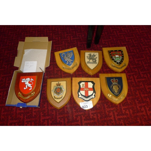 823 - 23 shield mounted wooden armorial plaques