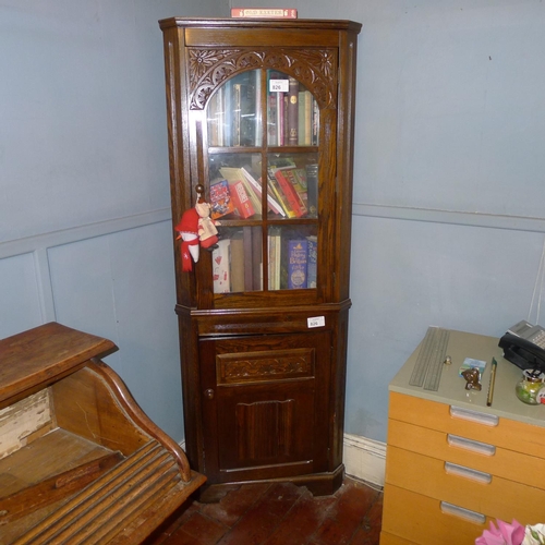 826 - Reproduction carved oak floor standing corner cabinet with a glazed door above and a panelled door b... 