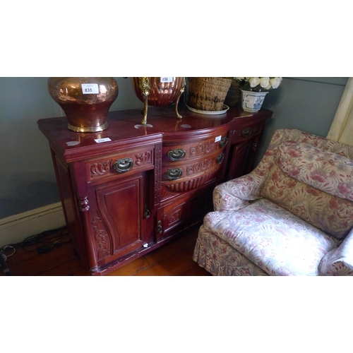 834 - An Edwardian carved mahogany bow front sideboard with drawers and cupboards