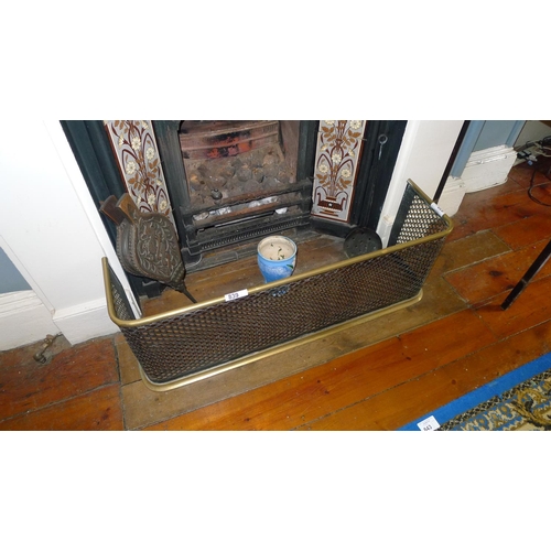 839 - A brass rail fireguard, a pair of wooden bellows and an iron chestnut roaster