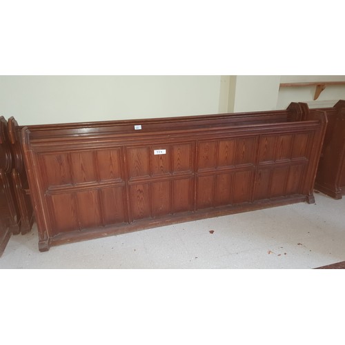 354 - A stained pine ecclesiastical pew, approximately 295cm wide complete with a matching front panel sec... 