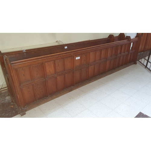 358 - A stained pine ecclesiastical pew, approximately 369cm wide complete with a front panel section