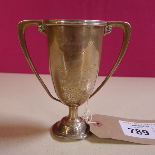 789 - A silver trophy cup  14 cms tall, weighted base