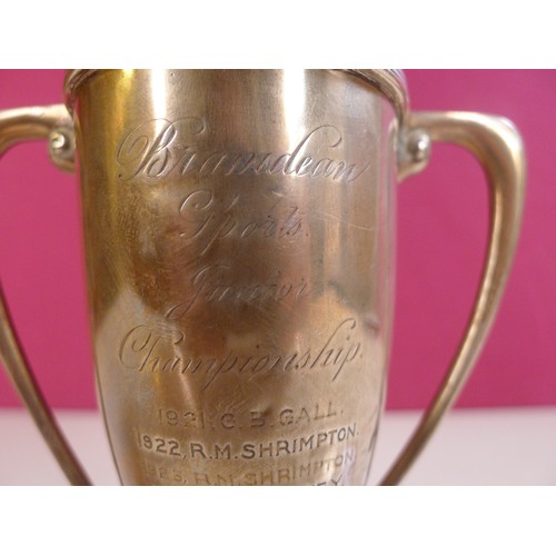 789 - A silver trophy cup  14 cms tall, weighted base