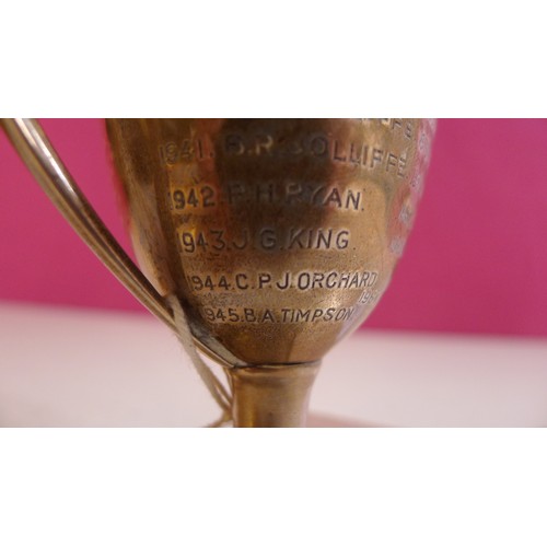 789 - A silver trophy cup  14 cms tall, weighted base