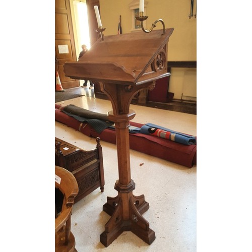 418 - A carved oak ecclesiastical style lectern with brass candle holders 156cm high, approx 60cm x 60cm s... 