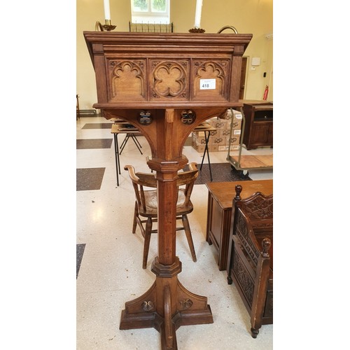 418 - A carved oak ecclesiastical style lectern with brass candle holders 156cm high, approx 60cm x 60cm s... 