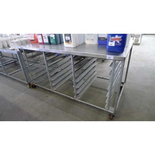 148 - 1 stainless steel wheeled table with shelf racks beneath (no shelves included) approx 173cm x 84cm x... 