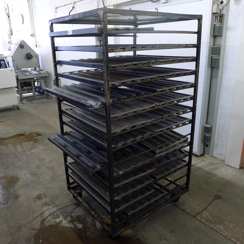 177 - 1 metal wheeled bakers rack containing a quantity of metal trays