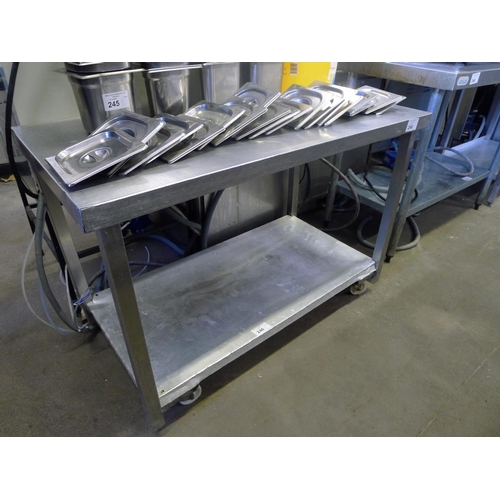 246 - 1 stainless steel wheeled table with 1 shelf beneath approx 114cm w x 61cm d x 79cm high