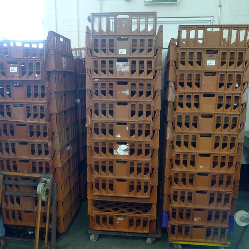 295 - 41 stacking plastic bread trays and 2 wheeled skates (terracotta coloured)