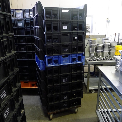 299 - 60 stacking plastic bread trays and 3 wheeled skates (mainly black coloured)