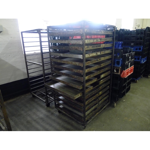 306 - 2 metal wheeled bakers racks - one of which contains a quantity of metal trays