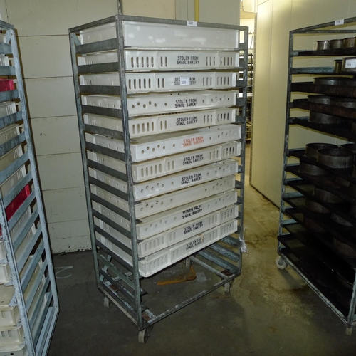 320 - 1 metal wheeled rack containing a quantity of plastic trays