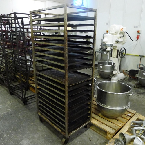 394 - 1 wheeled metal bakers rack containing a quantity of metal trays