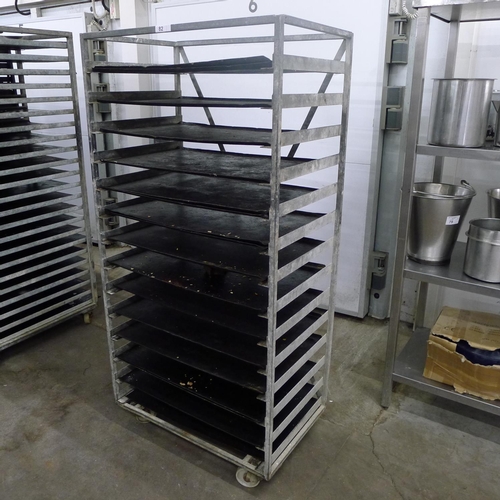 82 - 1 metal wheeled bakers rack containing a quantity of metal trays