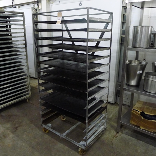 83 - 1 metal wheeled bakers rack containing a quantity of metal trays