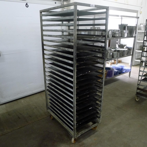 84 - 1 metal wheeled bakers rack containing a quantity of metal trays