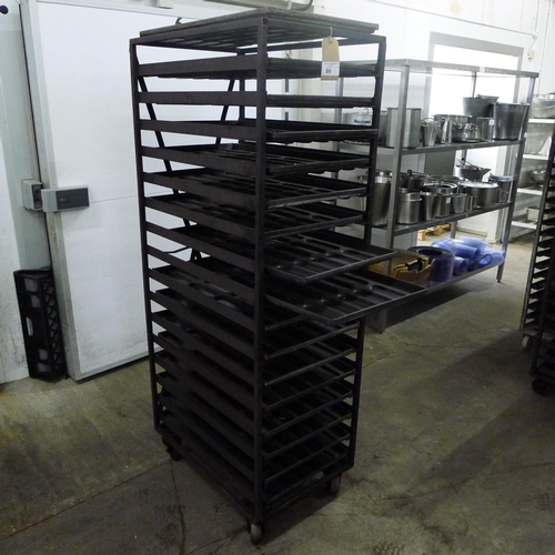 86 - 1 metal wheeled bakers rack containing a quantity of metal trays