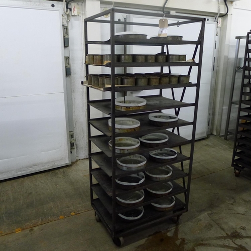 87 - 1 metal wheeled bakers rack containing a quantity of metal trays and tins