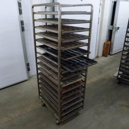 97 - 1 metal wheeled bakers rack containing a quantity of metal trays