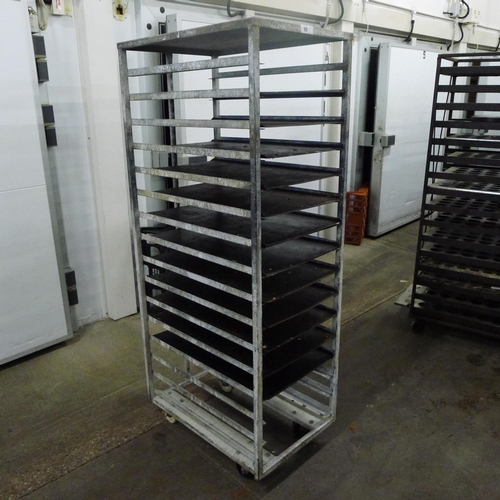 98 - 1 metal wheeled bakers rack containing a quantity of metal trays