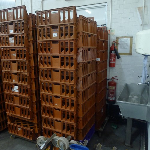 294 - 41 stacking plastic bread trays and 2 wheeled skates (mainly terracotta coloured)