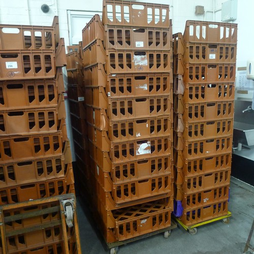 295 - 41 stacking plastic bread trays and 2 wheeled skates (terracotta coloured)