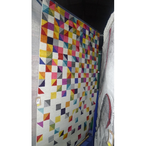 4494 - A multi coloured patterned rug type Carnival approx 5'×8'