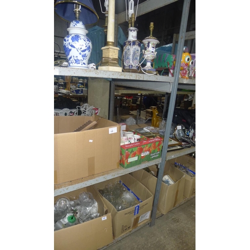 129 - A large quantity of various items including crockery, glasses, table lamps etc trade lot, contents o... 