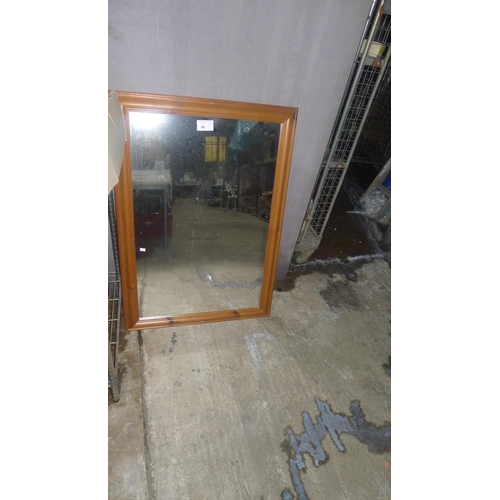 68 - A pine effect wooden framed mirror