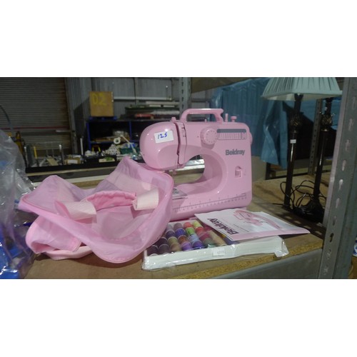 125 - A quantity of various items including a pink electric 12 stitch sewing machine by Beldray, roasting ... 